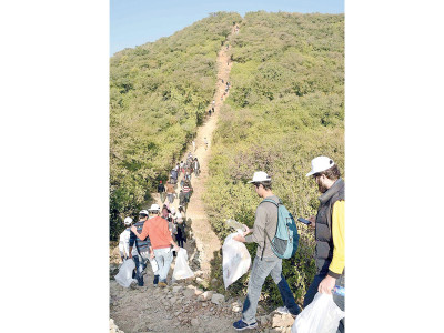 hike and clean up volunteers clean hiking trail at margallas