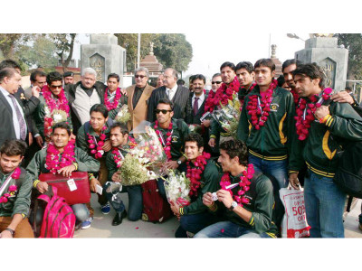 with silver medals around their neck the greenshirts return home
