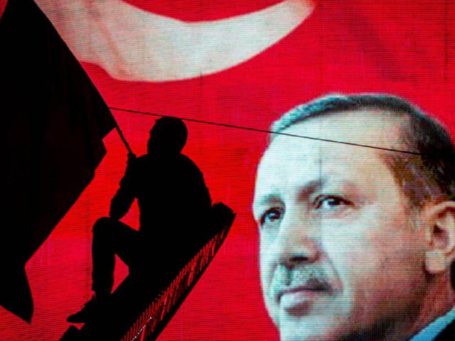 a supporter of turkish president recep tayyip erdogan waves a flag against an electronic billboard during a rally in ankara on july 18 2016 photo getty a supporter of turkish president recep tayyip erdogan waves a flag against an electronic billboard during a rally in ankara on july 18 2016 photo getty