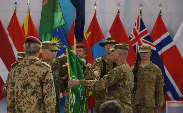 nato lowers flag on its afghan war but insurgency boils