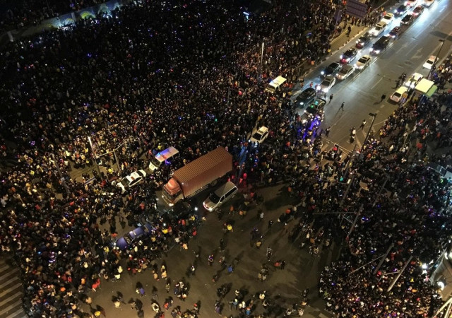this overhead view shows emergency vehicles c amongst the crowd after a stampede by new year 039 s revellers in shanghai 039 s historic riverfront in shanghai on january 1 2015 photo afp this overhead view shows emergency vehicles c amongst the crowd after a stampede by new year 039 s revellers in shanghai 039 s historic riverfront in shanghai on january 1 2015 photo afp
