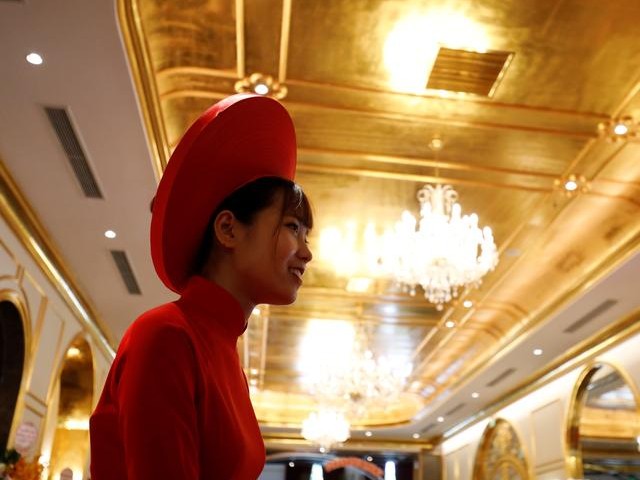 An employee in traditional dress is seen in the newly-inaugurated Dolce Hanoi Golden Lake luxury hotel, which features gold plated exteriors and interiors in Hanoi, Vietnam. PHOTO: REUTERS