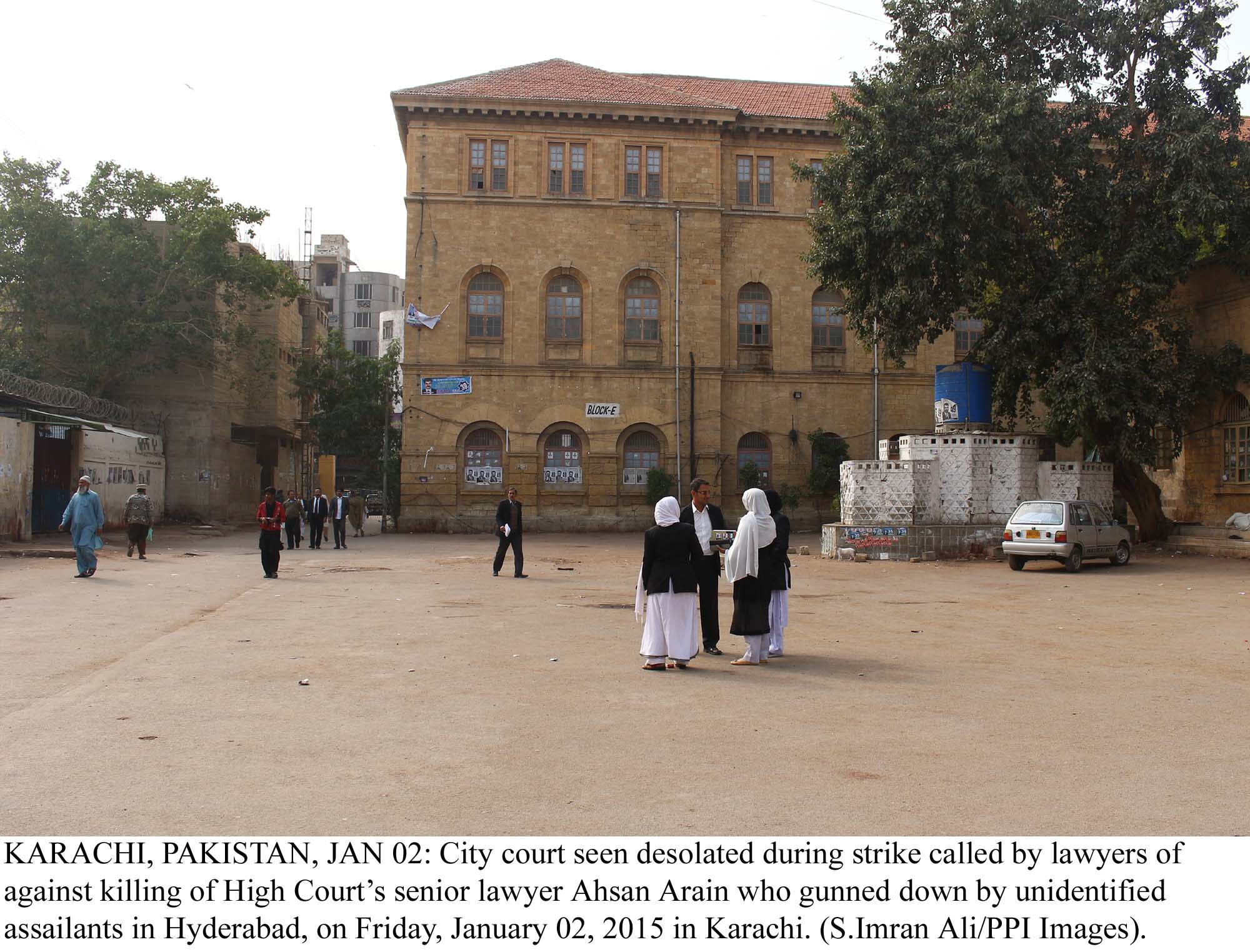 lawyers stand outside a deserted city court in karachi during a strike against the murder of ahsan arain in hyderabad on friday photo ppi