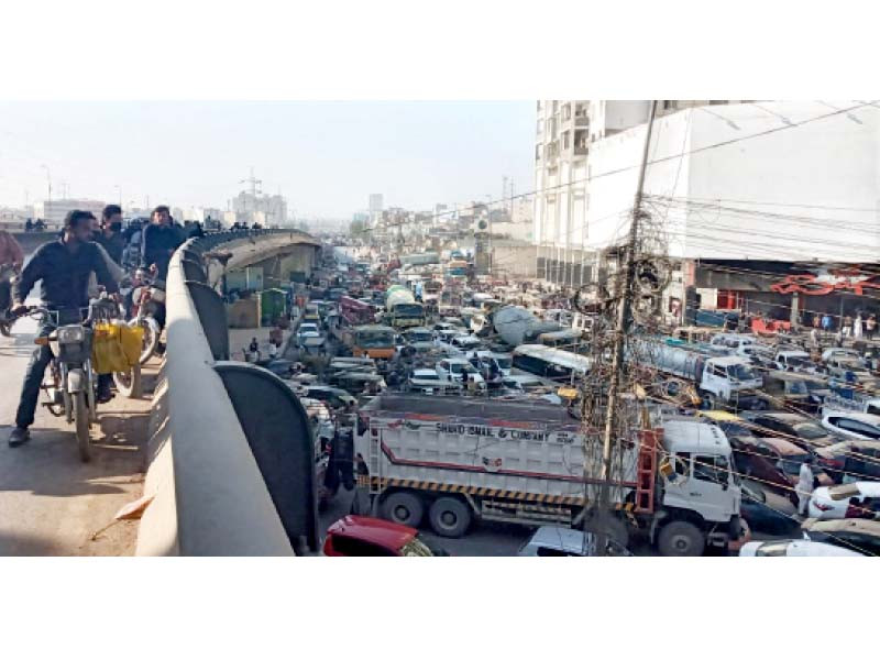 people are stuck in a traffic jam due to a protest against gas supply cuts at qayumabad intersection on friday photo express