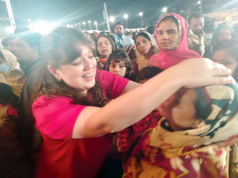 a pastor from russia applies spiritual healing to a woman at a prayer gathering in karachi photo express