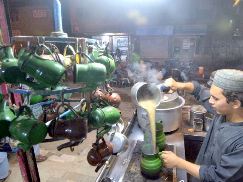 the aroma of steaming tea fills a roadside tea shop as people wait for their orders for a small teapot or a full cup locally called chainak or a short one known as cut chai photo jalal qureshi express