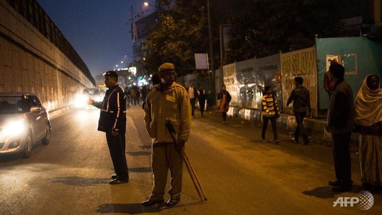 indian police direct traffic in new delhi on dec 16 2014 during a vigil to mark the second anniversary of the fatal gang rape of a student in the indian capital photo afp