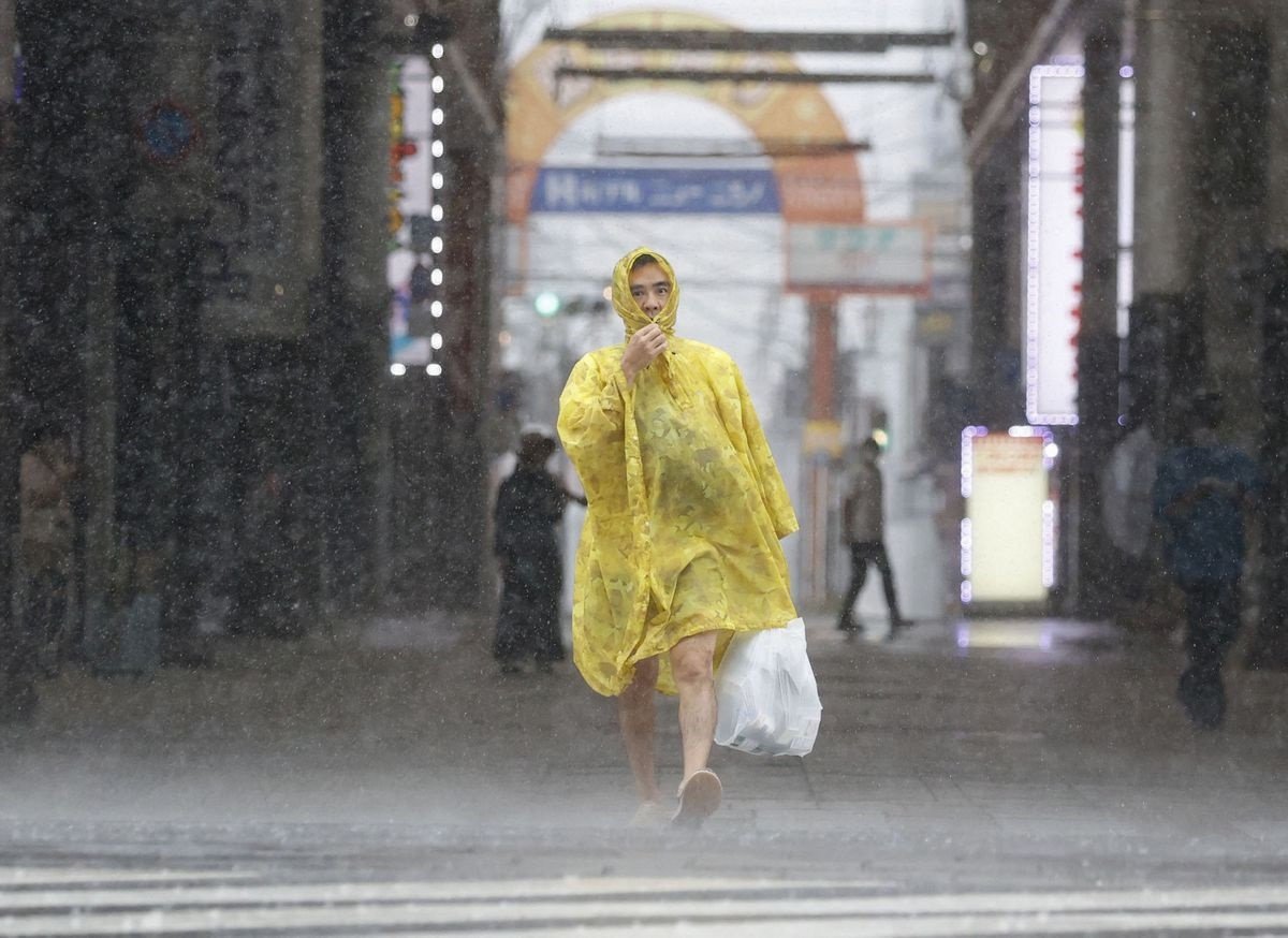 A man walks on the street in heavy rain and wind caused by Typhoon Nanmadol in Kagoshima on Japan's southernmost main island of Kyushu September 18, 2022, in this photo taken by Kyodo. Kyodo via REUTERS ATTENTION EDITORS - THIS IMAGE WAS PROVIDED BY A THIRD PARTY. MANDATORY CREDIT. JAPAN OUT. NO COMMERCIAL OR EDITORIAL SALES IN JAPAN