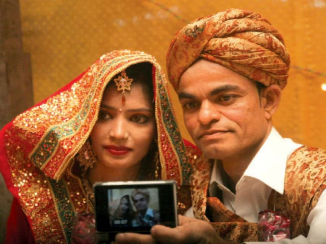 a newly wedded couple takes a selfie at the colourful mass wedding ceremony arranged by the pakistan hindu council at the ymca ground on friday night photo athar khan express