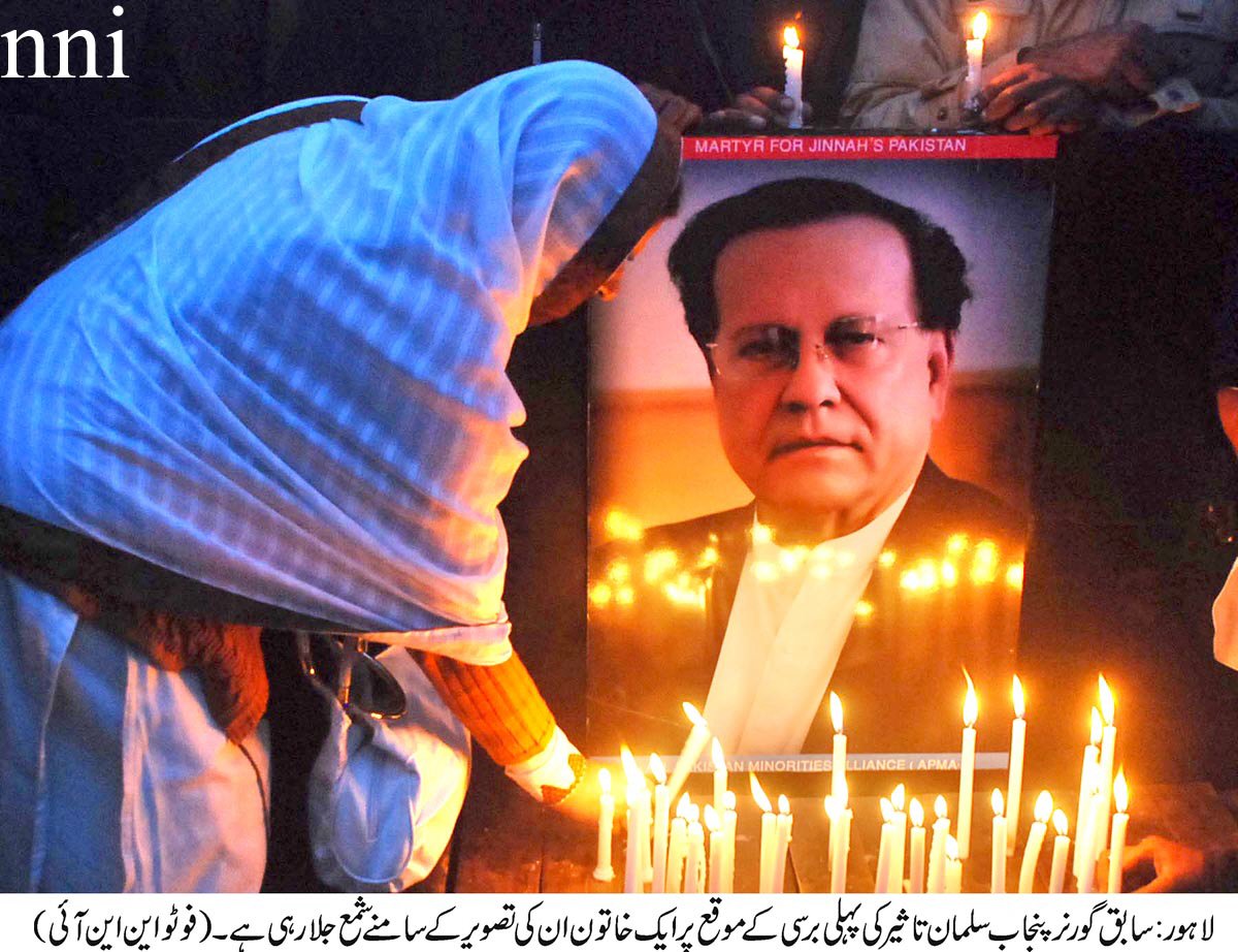 a woman lights a candle at a remembrance ceremony held for former governor punjab salmaan taseer in lahore on wednesday photo nni