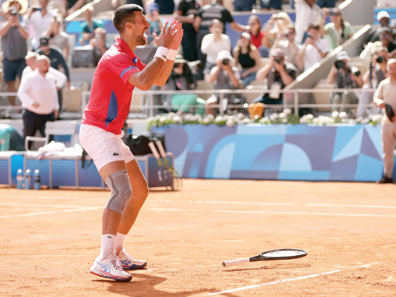 novak djokovic of serbia celebrates after winning gold against carlos alcaraz of spain photo reuters