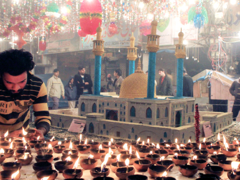 a man lights clay lamps photo abid nawaz shafiq malik express