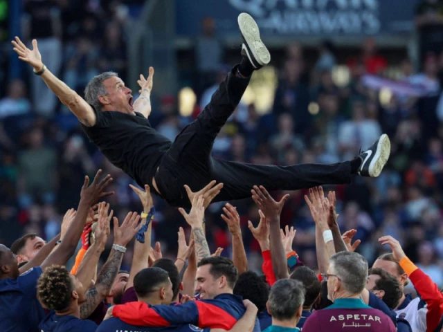 paris saint germain s players celebrate winning the french league title in paris on saturday with coach luis enrique hoisted in the air photo afp paris saint germain s players celebrate winning the french league title in paris on saturday with coach luis enrique hoisted in the air photo afp