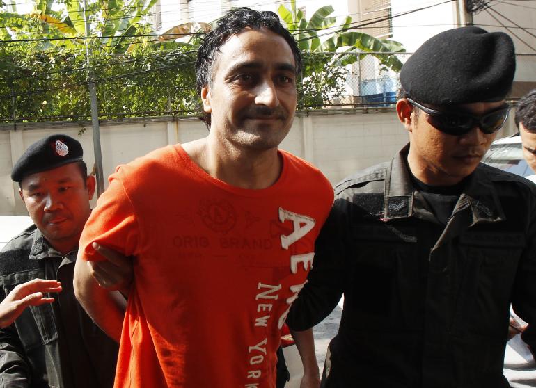 police officers escort gurmeet singh also known as jagtar singh tara from india as they arrive at the criminal court in bangkok on january 6 2015 photo reuters