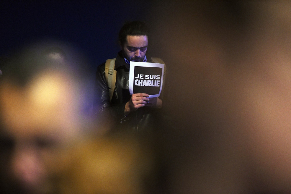 a man holds a placard reading quot i am charlie quot during a gathering at the old harbor in marseille on january 7 2015 following an attack by unknown gunmen on the offices of the satirical weekly charlie hebdo photo afp