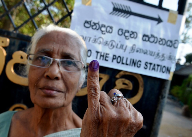 a sri lankan woman holds up her inked finger after voting in the country 039 s election at a polling station in the north central town of polonnaruwa some 240 kms from colombo on january 8 2015 photo afp a sri lankan woman holds up her inked finger after voting in the country 039 s election at a polling station in the north central town of polonnaruwa some 240 kms from colombo on january 8 2015 photo afp