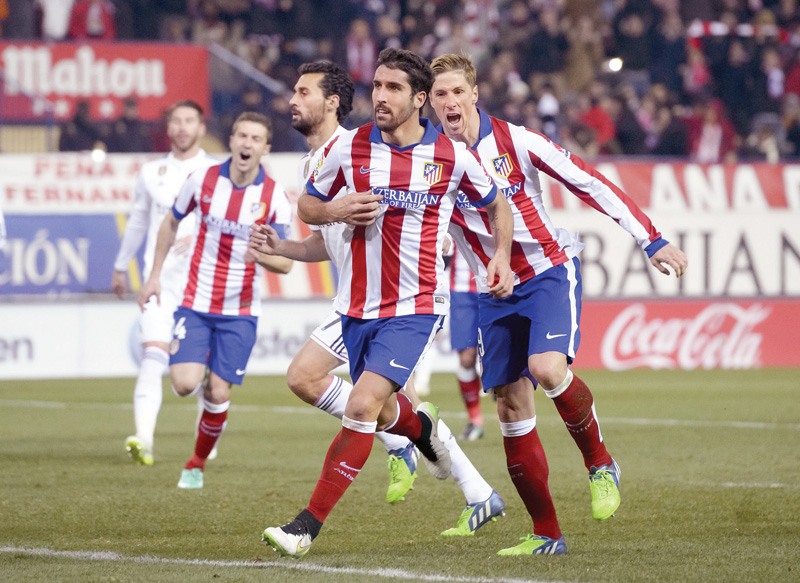 raul garcia celebrates after scoring from the spot with torres running up to celebrate his new teammate photo afp