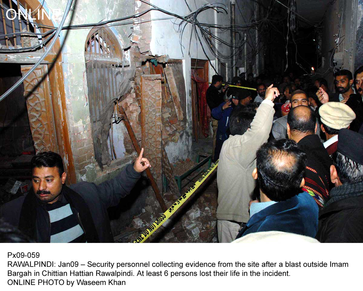 officials stand outside the imambargah where the blast took place photo online