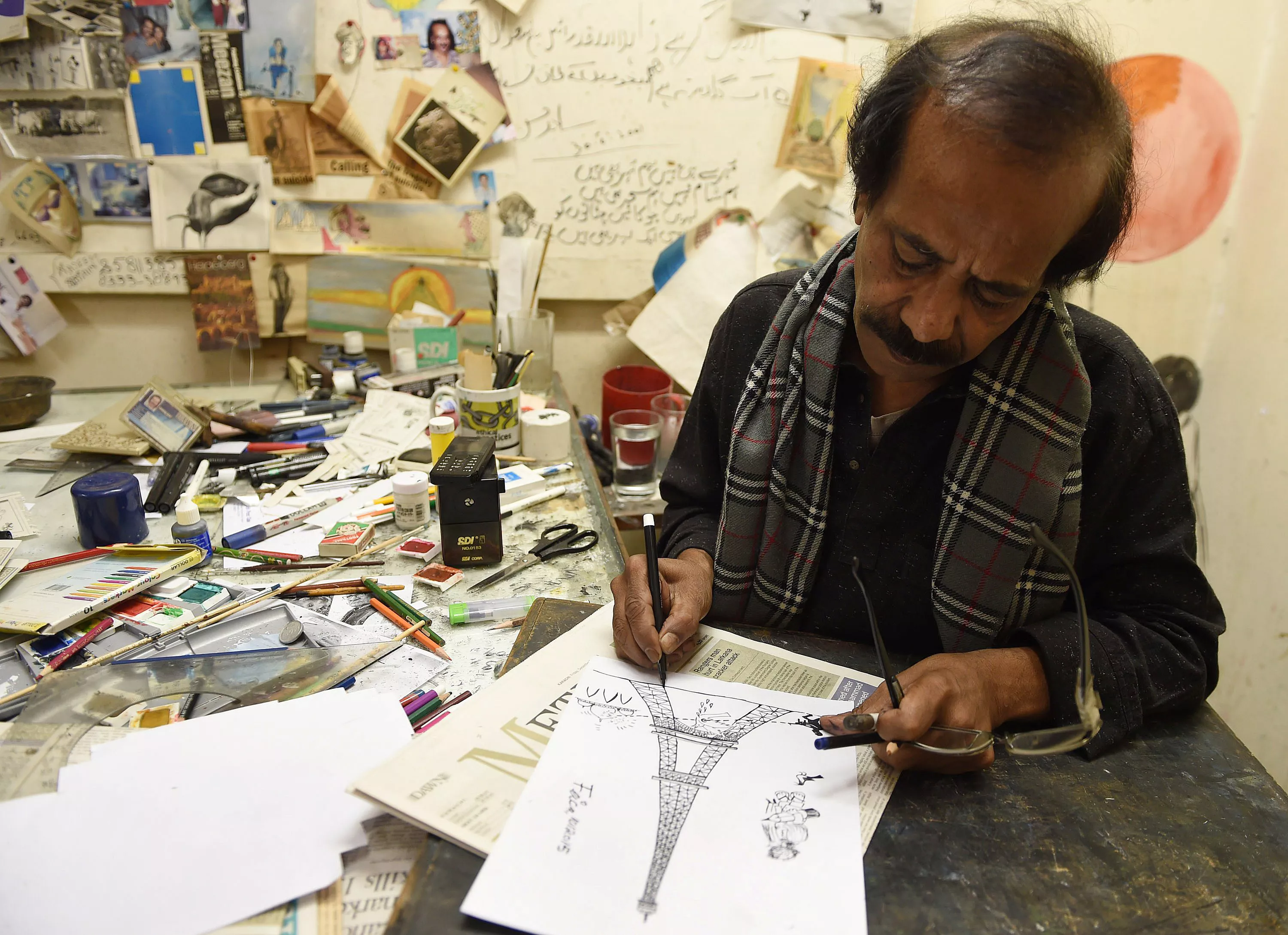 in this photograph taken on january 9 2015 pakistani cartoonist rafique ahmad alias quot feica quot draws at his office in karachi photo afp in this photograph taken on january 9 2015 pakistani cartoonist rafique ahmad alias quot feica quot draws at his office in karachi photo afp