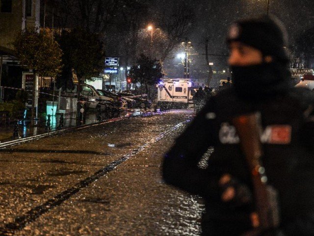 a turkish police officer stands guard along a street leading to where a female suicide bomber was killed on january 6 2015 when she blew herself up in an attack on the police station in the main tourist district of istanbul photo afp