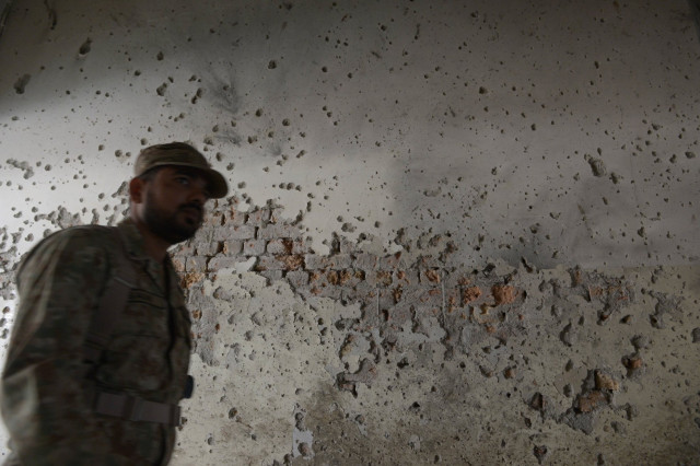 an army soldier walks past a bullet riddled wall at the army public school in peshawar on december 17 2014 photo afp an army soldier walks past a bullet riddled wall at the army public school in peshawar on december 17 2014 photo afp