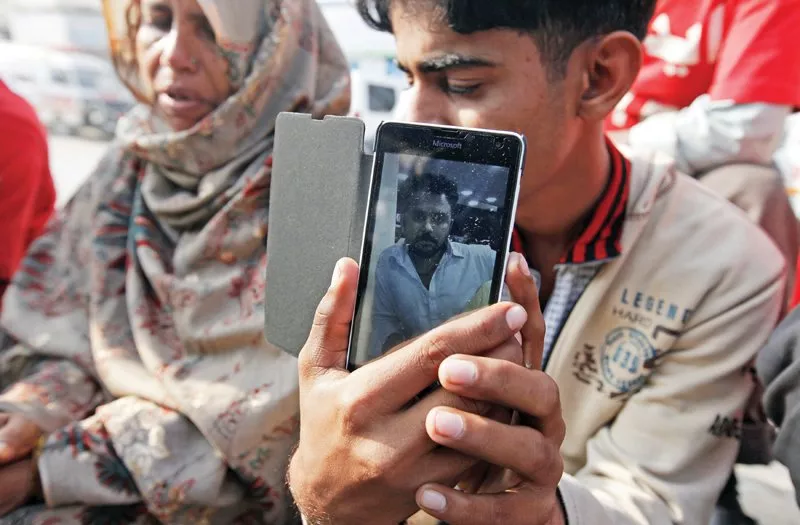 a boy holds a picture of his relative who was killed in saturday s accident at least 62 people were killed and several others were injured on the highway officials said photos reuters