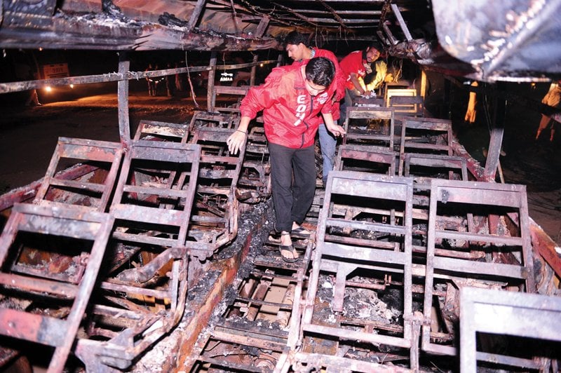 volunteers sift through the wreckage of the passenger bus photo afp