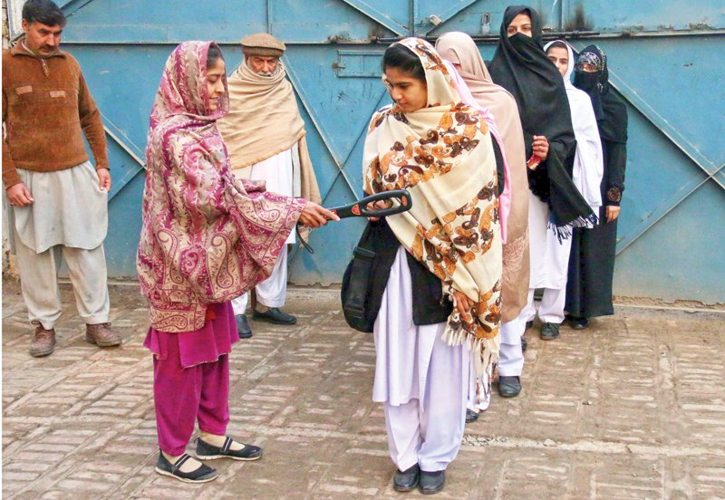 students of lady griffith high school undergo a security check before entering the school s premises photo muhammad iqbal express