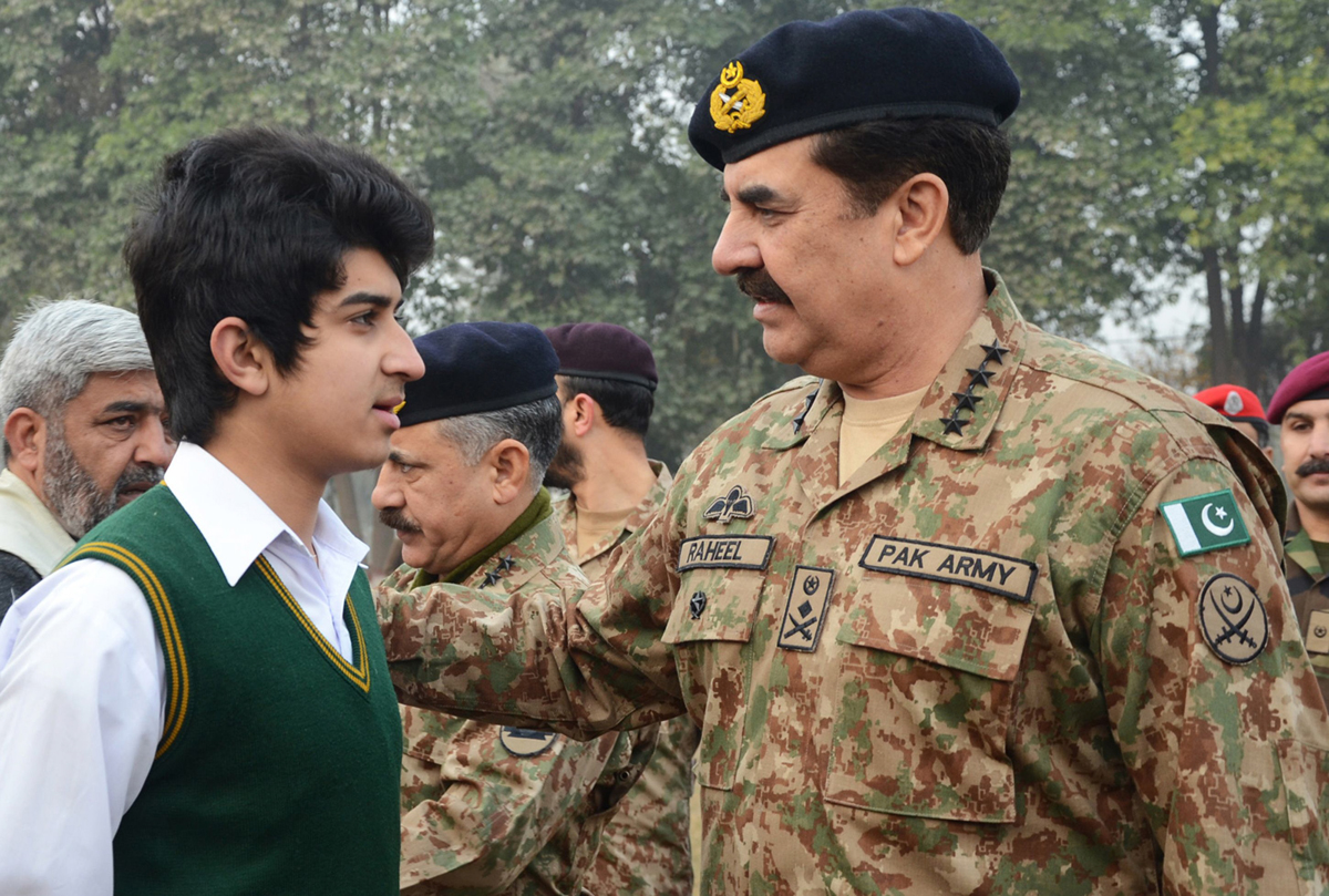 this handout photograph released by inter services public relations ispr office on january 12 2015 shows army chief raheel sharif r speaking with a student at the army public school after it was reopened following an attack there by taliban militants in peshawar photo afp