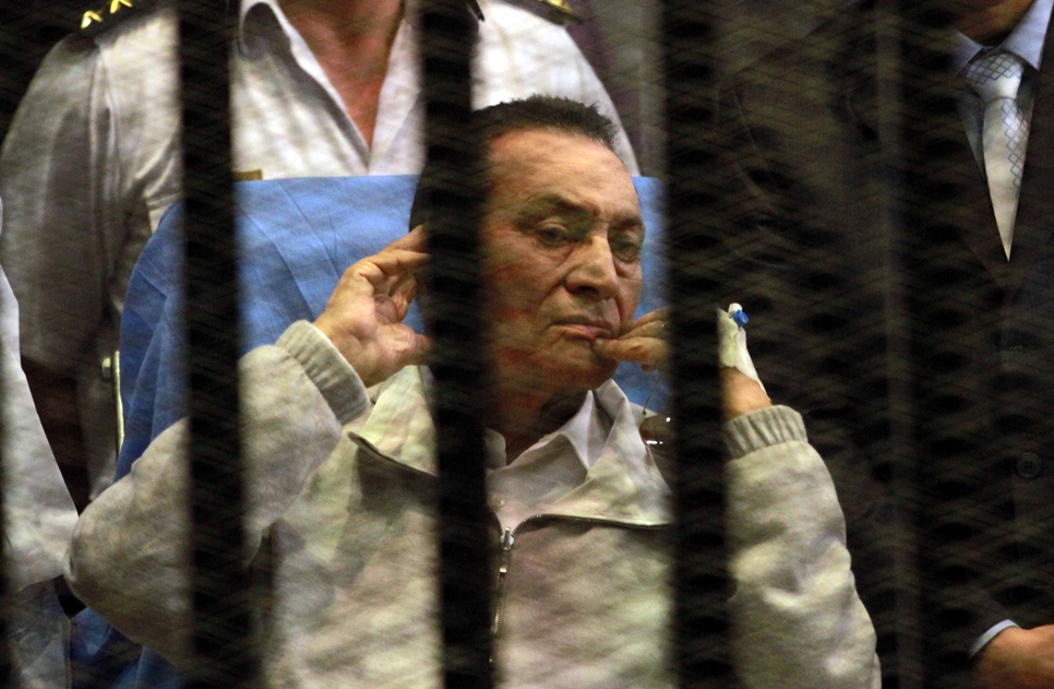 in this file photo ousted egyptian president hosni mubarak sits behind bars during his retrial at the police academy in cairo on april 15 2013 photo afp