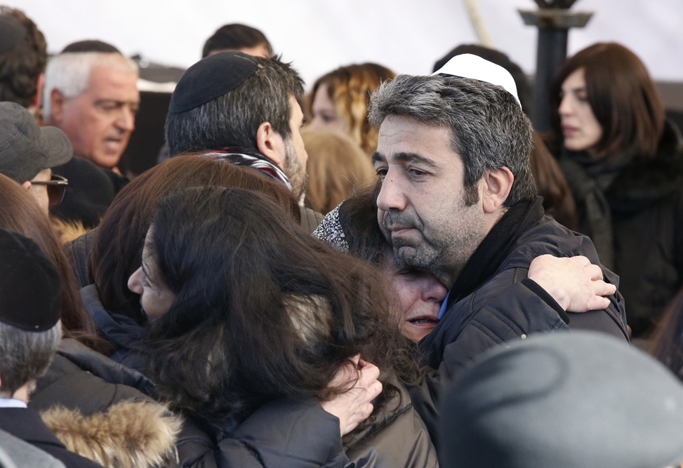 israeli mourners hug before the funeral in jerusalem on january 13 2015 of four french jews killed in an attack on a kosher supermarket in paris last week photo afp