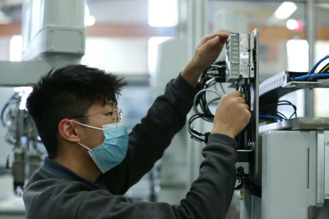 an employee works on a production line at hahn automation company in rheinboellen germany november 11 2020 photo reuters an employee works on a production line at hahn automation company in rheinboellen germany november 11 2020 photo reuters