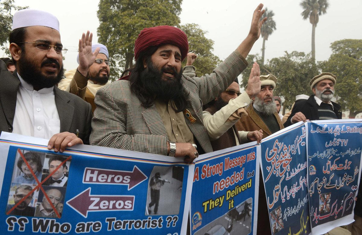 people march with placards during a solidarity rally for the two killed assailants who attacked french satirical weekly charlie hebdo in peshawar on january 13 2015 photo afp