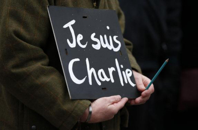 a man holds a 039 je suis charlie 039 banner during a march in liverpool photo reuters a man holds a 039 je suis charlie 039 banner during a march in liverpool photo reuters