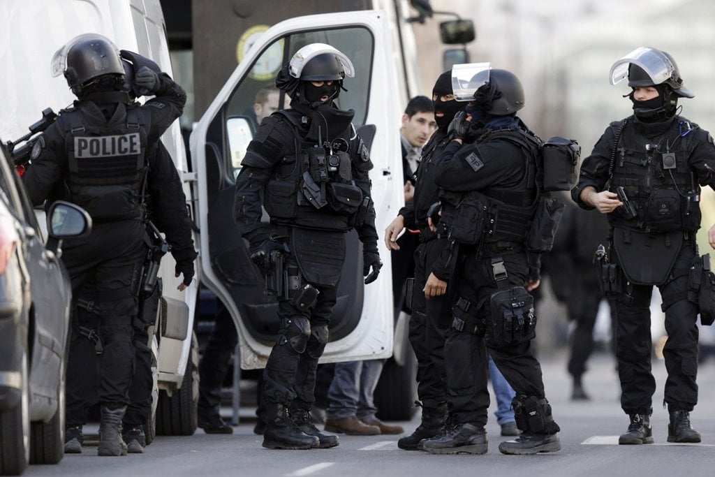 french research and intervention brigades bri policemen officers prepare near the post office where an armed man holed up with two hostages photo afp