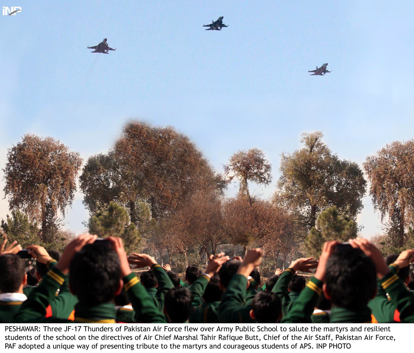 kids punch the air as paf 039 s jf 17 fighter jets fly over their school on friday photo inp