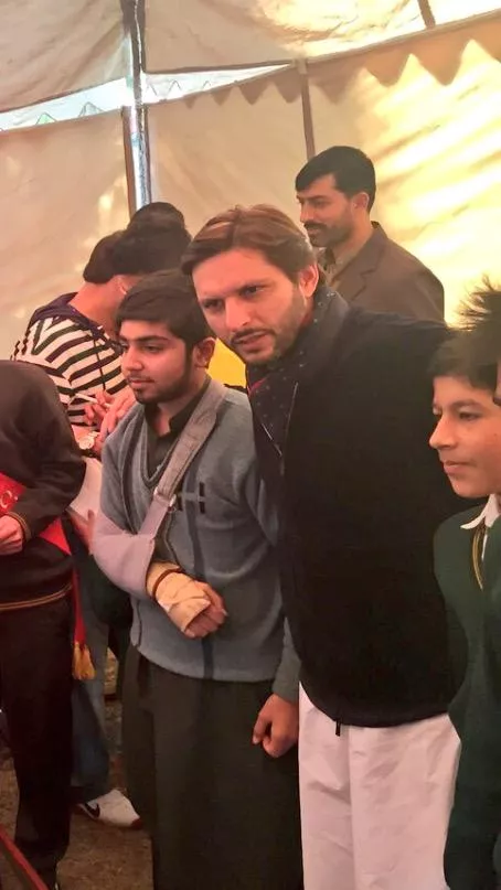 shahid afridi with students of the army public school photo safridiofficial twitter shahid afridi with students of the army public school photo safridiofficial twitter