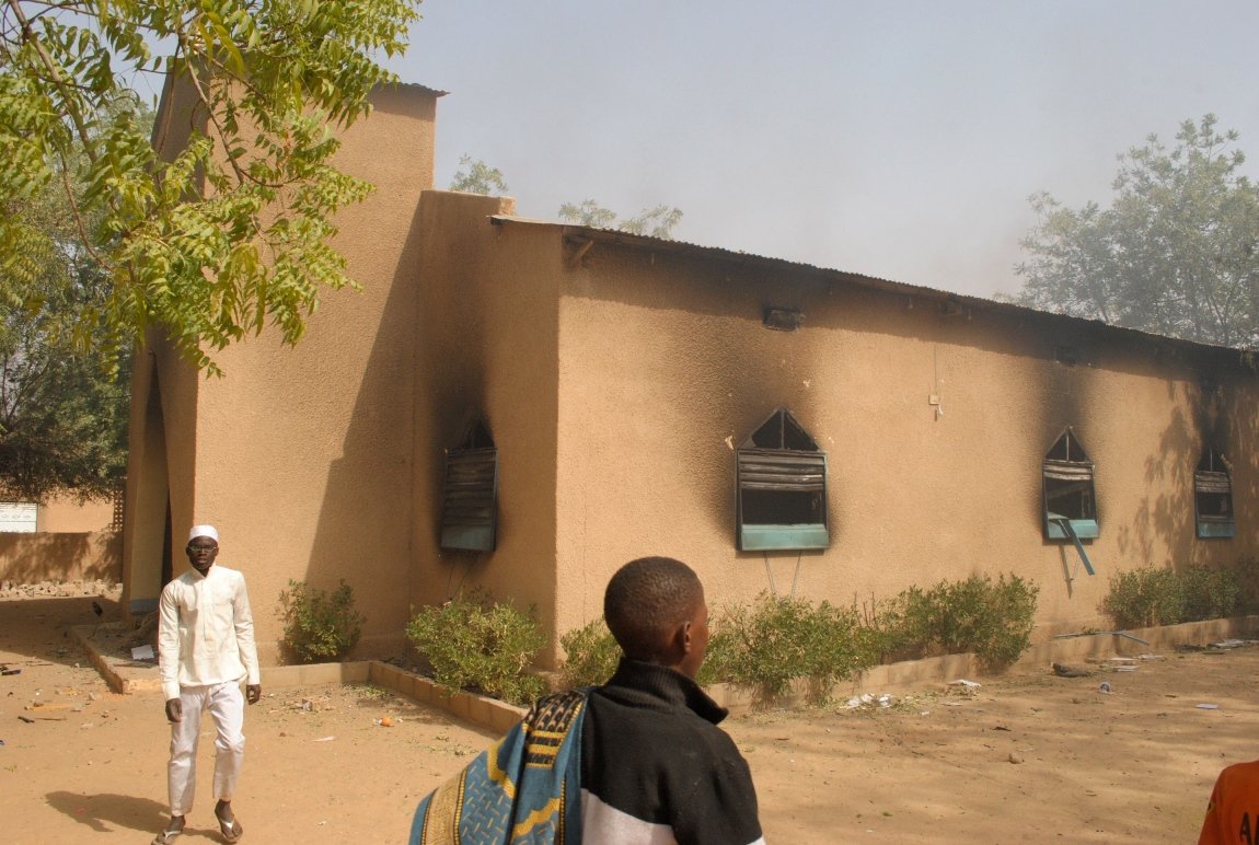 residents watch a ransacked church in zinder that burned after thousands of protesters gathered following friday prayers to vent anger at the depiction of prophet mohammad pbuh in the latest edition of charlie hebdo photo afp