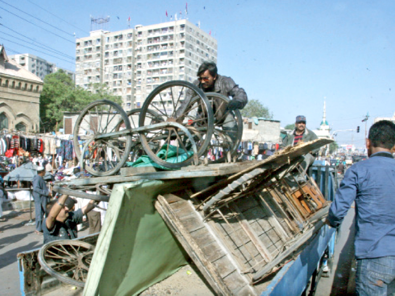 makeshift stalls are removed during an anti encroachment drive near empress market in saddar the efforts usually go to waste with the encroachers often returning after the end of each drive photo athar khan express