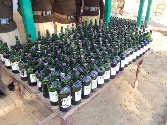 bmp officials show a cache of 1 073 liquor bottles seized at a check post photo express