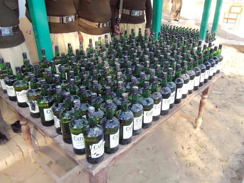 bmp officials show a cache of 1 073 liquor bottles seized at a check post photo express bmp officials show a cache of 1 073 liquor bottles seized at a check post photo express
