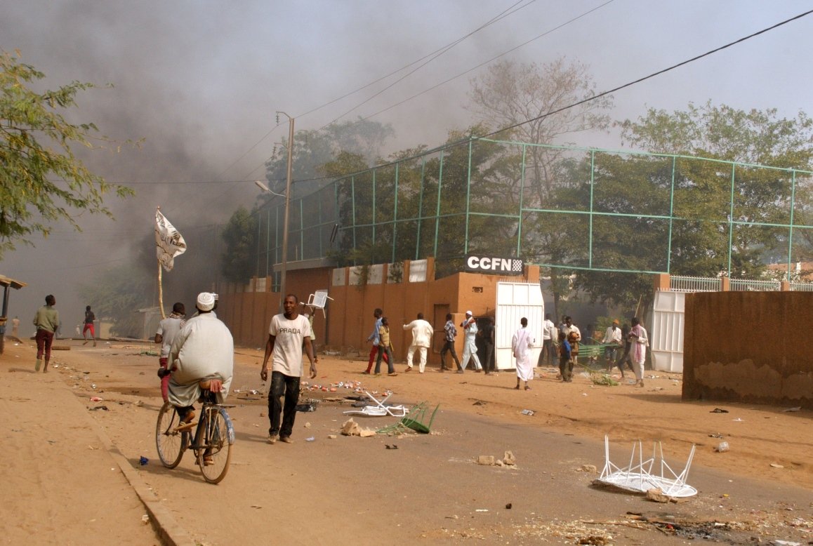 smoke rises from the franco nigerien cultural center ccfn in zinder after it was burned down during demonstrations after friday prayer on january 16 2014 photo afp