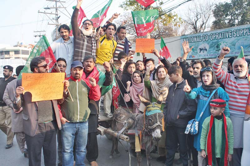 some pti workers drove a donkey cart to lahore press club to protest petrol shortage photo abid nawaz express