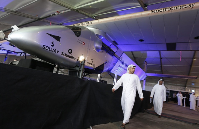 emirati men walk past the solar impulse 2 the first solar powered plane to be able to fly for several days and nights on january 20 2015 photo afp emirati men walk past the solar impulse 2 the first solar powered plane to be able to fly for several days and nights on january 20 2015 photo afp