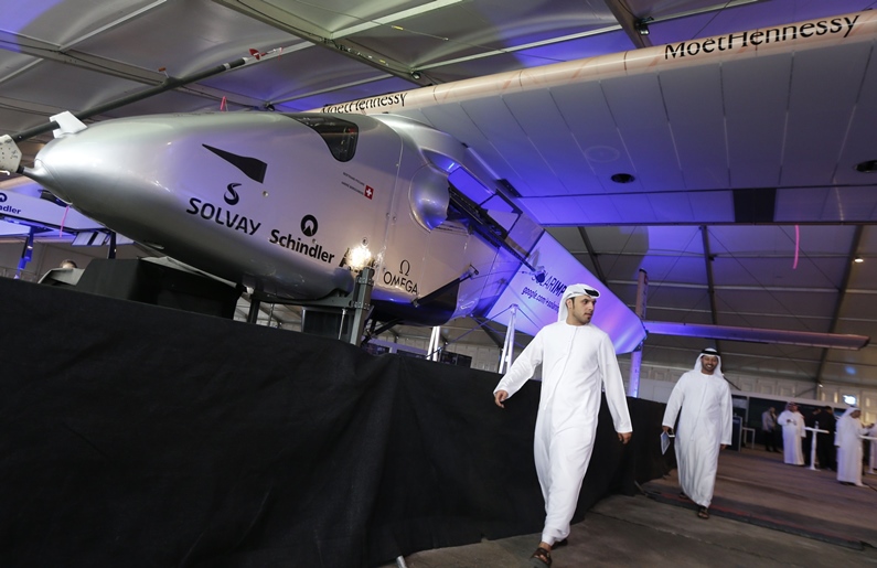 emirati men walk past the solar impulse 2 the first solar powered plane to be able to fly for several days and nights on january 20 2015 photo afp