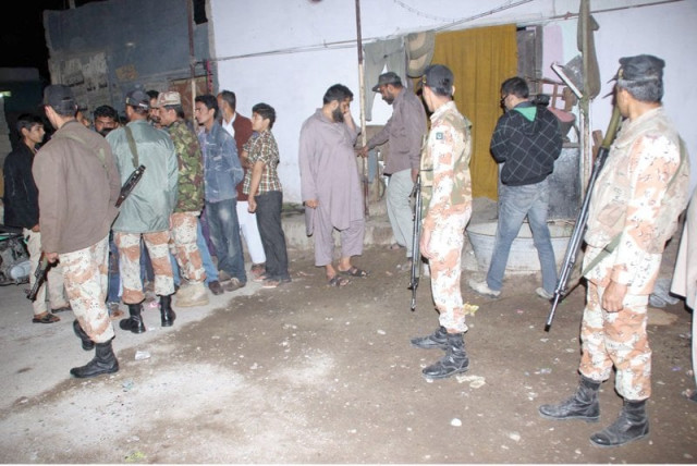 rangers collect evidence outside a police compound following a grenade attack in lyari photo ppi rangers collect evidence outside a police compound following a grenade attack in lyari photo ppi