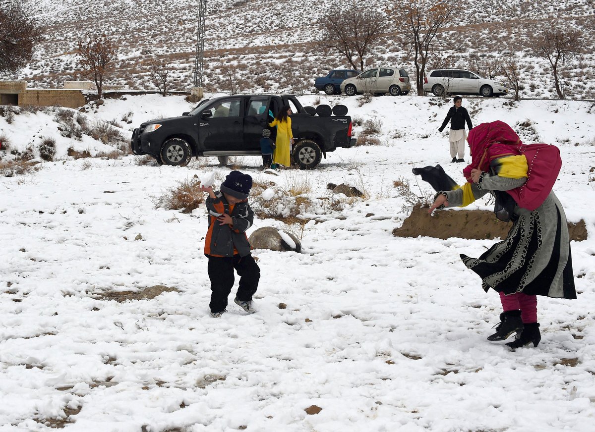 local residents enjoy the snow fall on the outskirts of quetta on january 21 2015 photo afp