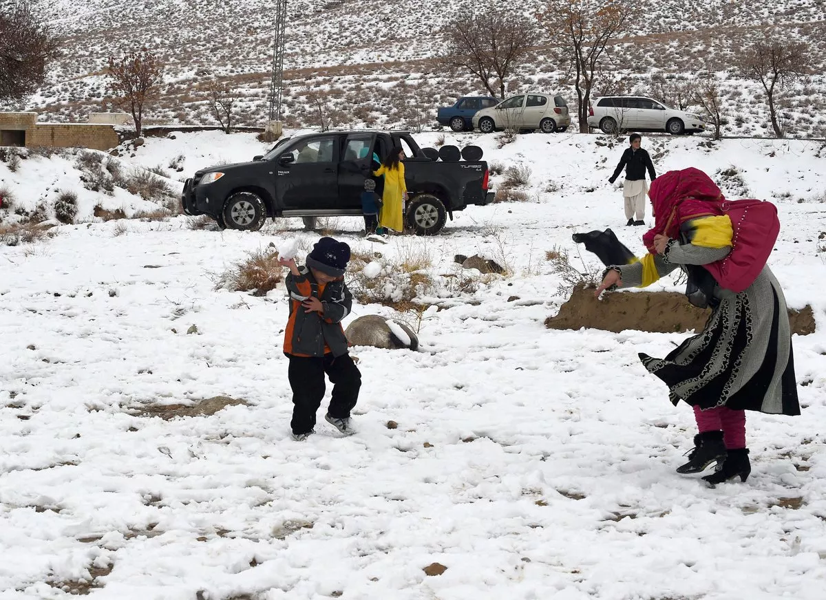 local residents enjoy the snow fall on the outskirts of quetta on january 21 2015 photo afp local residents enjoy the snow fall on the outskirts of quetta on january 21 2015 photo afp