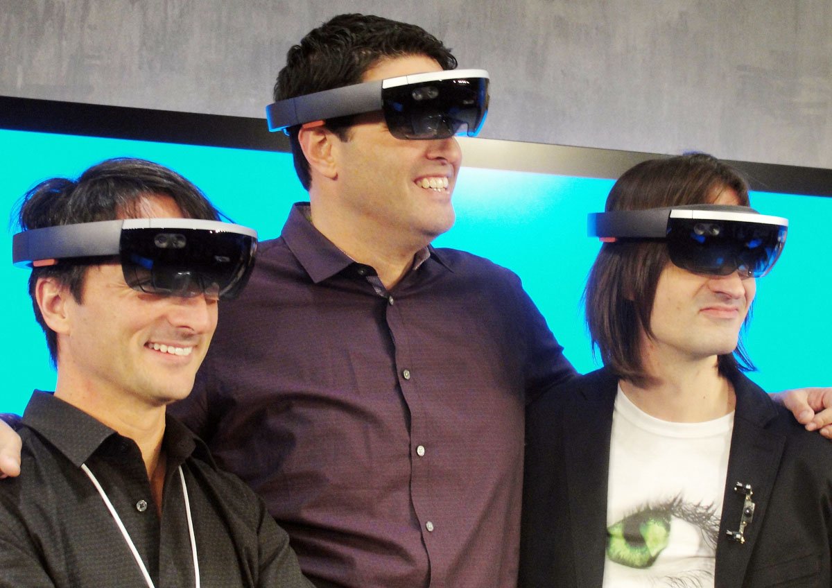 microsoft executives l r joe belfiore terry myerson and alex kipman pose with the hololens eyewear that overlays 3d images on the real world at a press event at the technology titan 039 s main campus in redmond washington on january 21 2015 photo afp