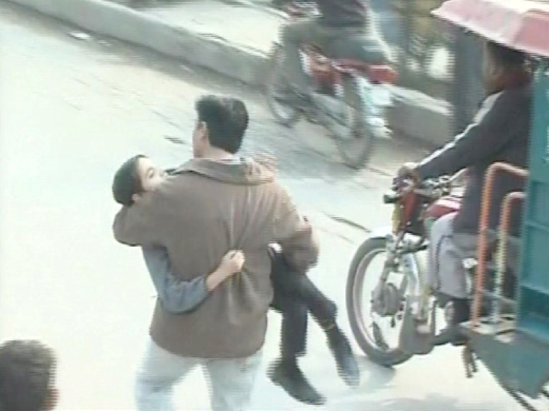 fahad ilyas s father carrying him after he was injured at the demonstration photo express